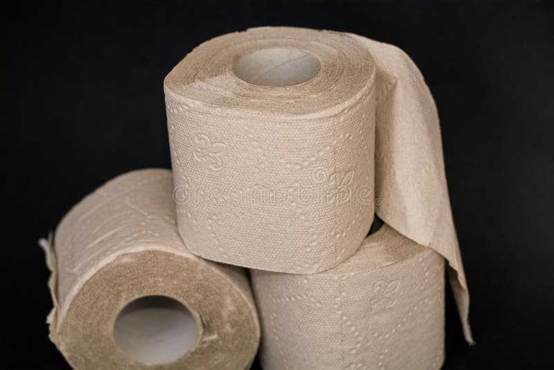 On Black Background, Three Piles of Grey Open Toilet Paper. Stock Photo