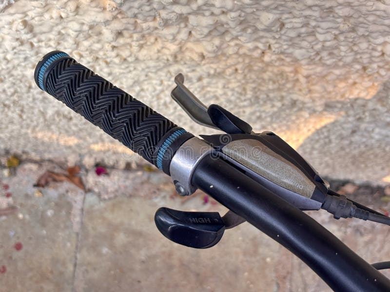 A black bicycle handlebar with a blue stripe royalty free stock photos