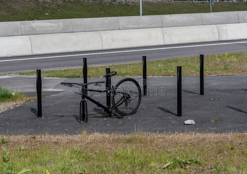 Black Bicycle Locked To a Bicke Rack. Front Wheel Stolen.. Stock Photo