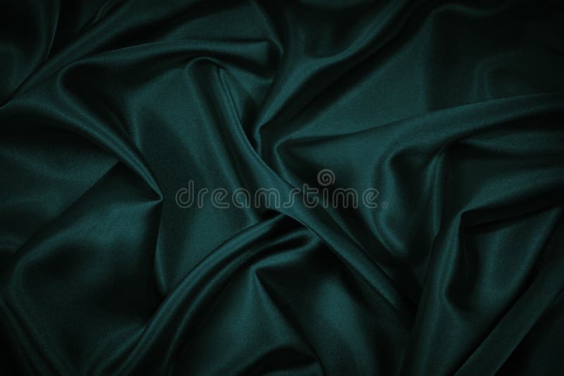 Black blue green abstract background. Dark green silk satin texture background. Beautiful wavy soft folds on the surface of the fa