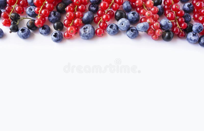 Black-blue and red food on a white. Ripe blueberries, red currants and black currants on a white background.