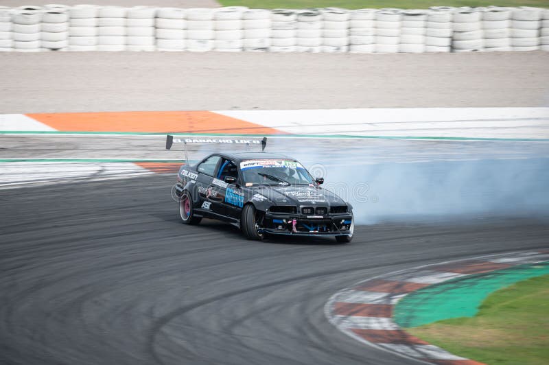 Black BMW E36 Producing Smoke on a Trail for a Drift Competition