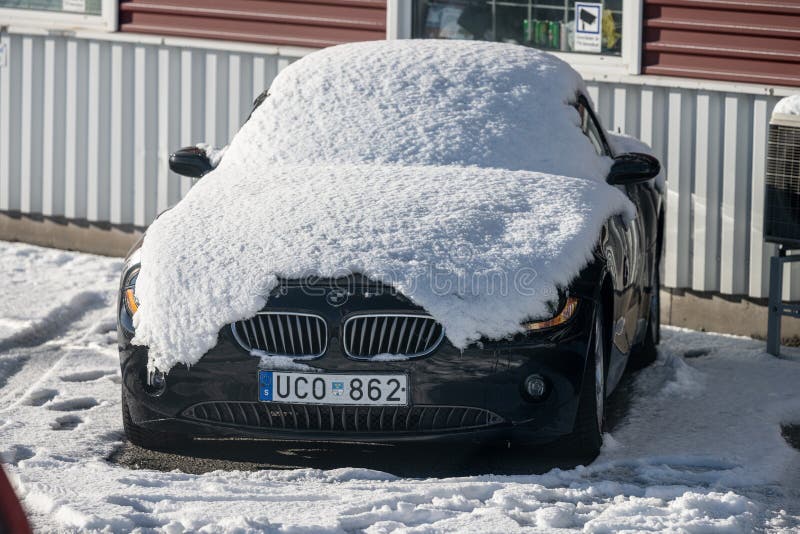 BMW badge covered in snow Stock Photo - Alamy