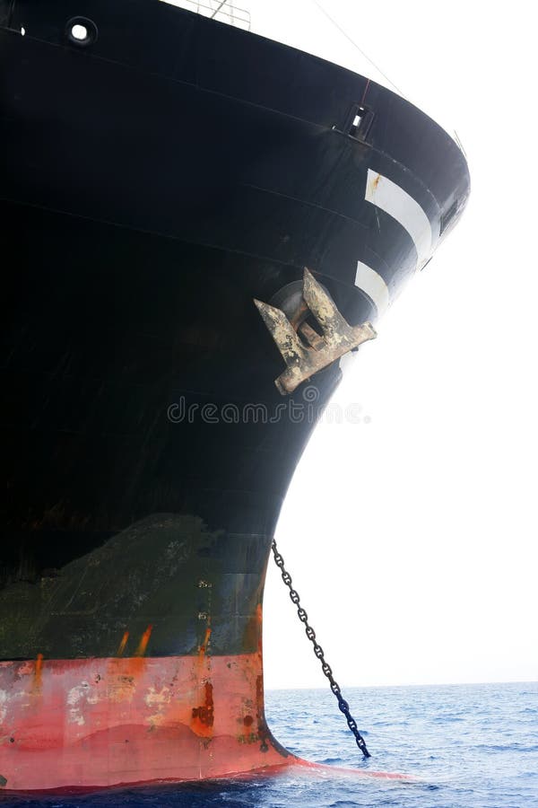 Black boat anchored on sea blued water