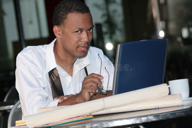 Black Business Man Working Outdoors on a Laptop