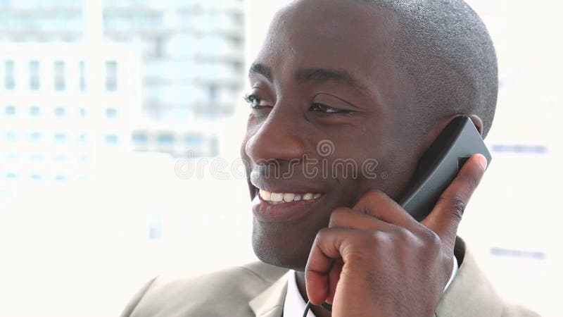 Black businessman smiling on the phone