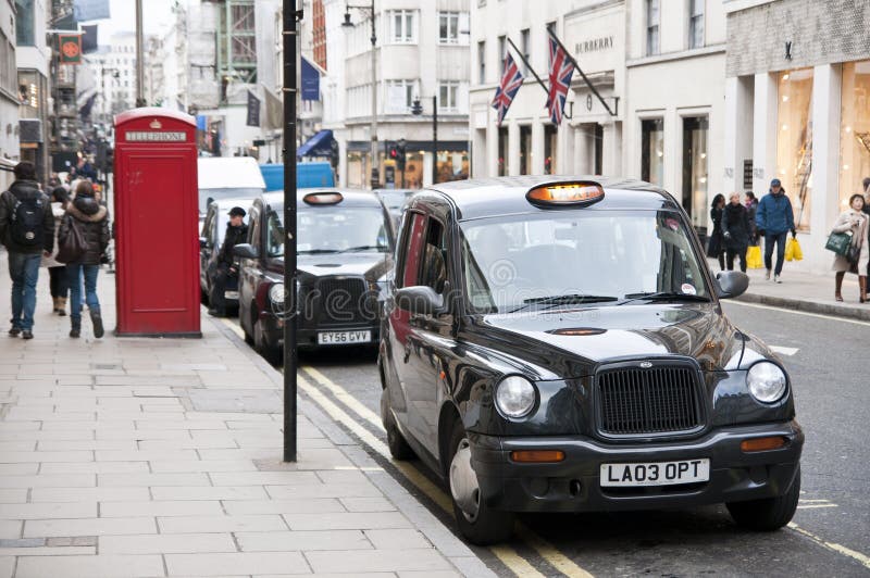 Black cabs parked in New Bond street in London. royalty free stock photos