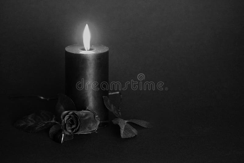 Black candle, black rose, glass heart.