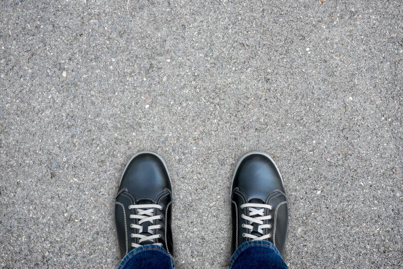 Black casual shoes standing on concrete floor