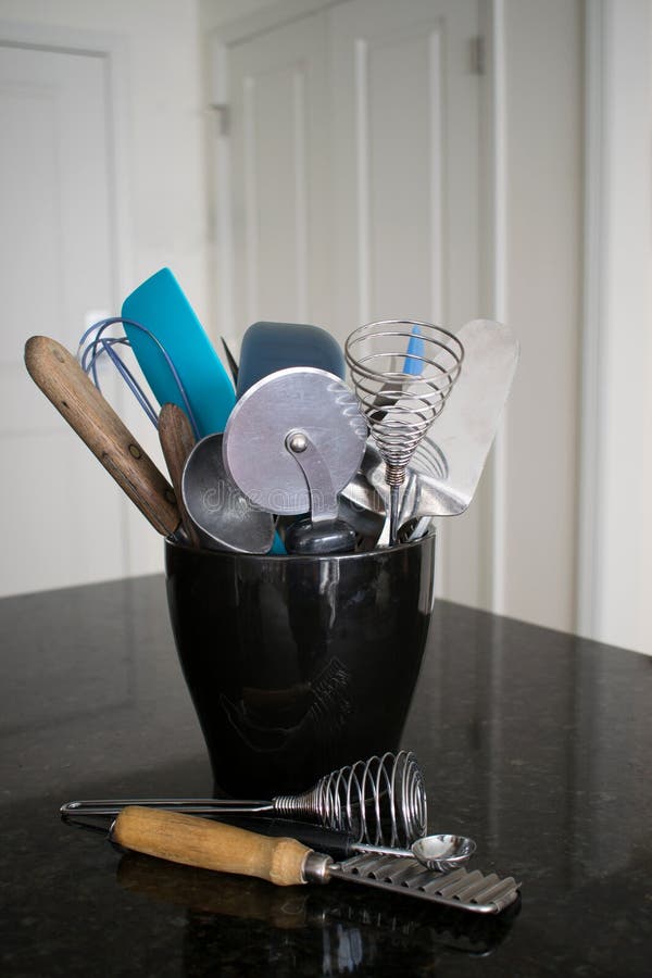 A Black Ceramic Container Holding Many Kitchen Utensils Stock Image