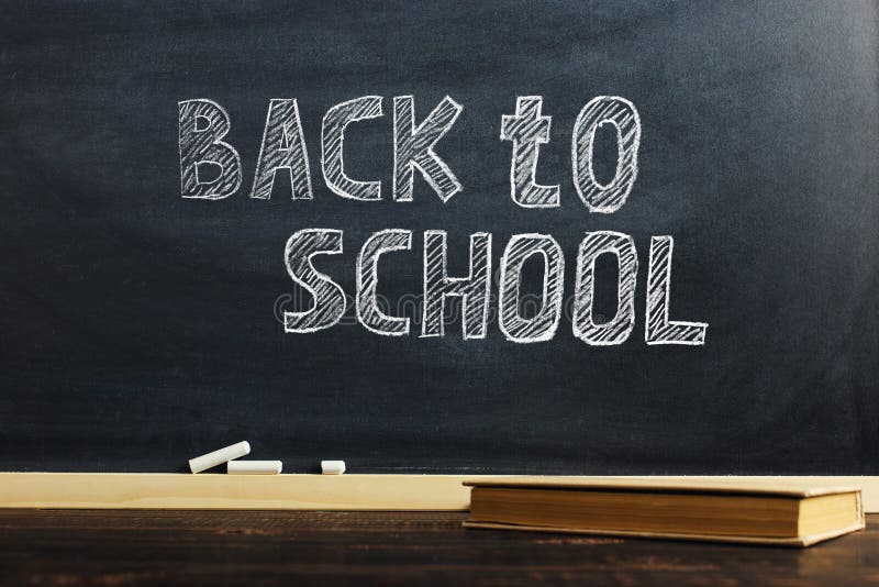 Black chalk board over wooden table with book, blank for text or background for school theme royalty free stock image Black chalk board over wooden table with book, blank for text or background for school theme royalty free stock image