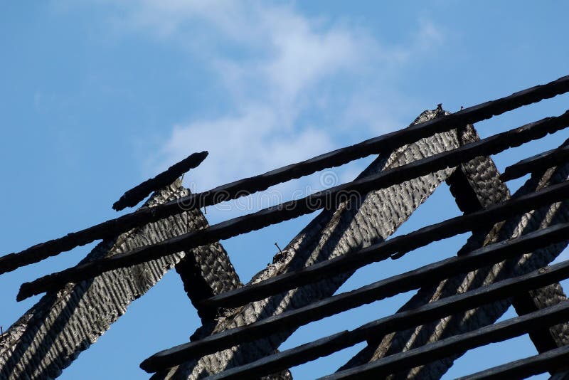 Black Charred Burnt Wooden Roof Rafters After Fire Under Blue Sky Stock Image Image of
