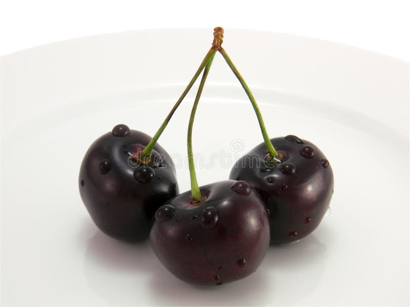 Black cherry on a white plate close-up