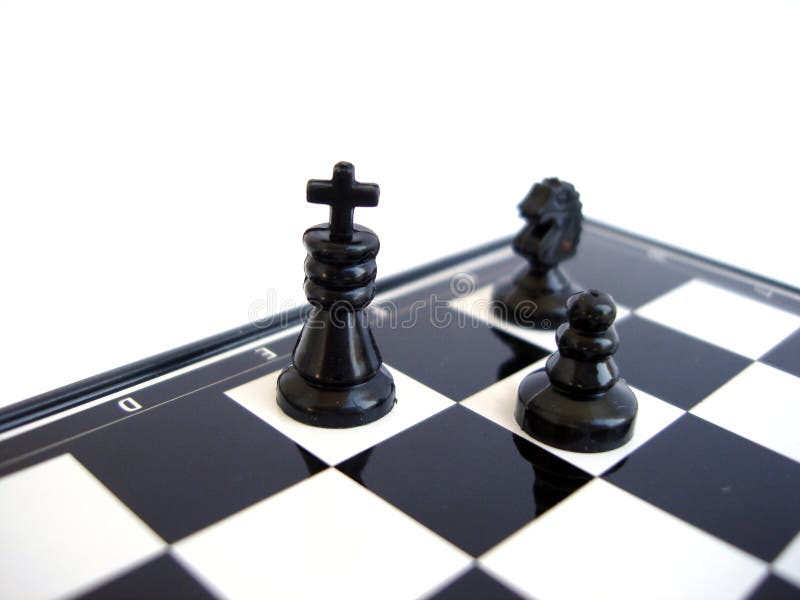 Black chess king stands with figure on a chess board