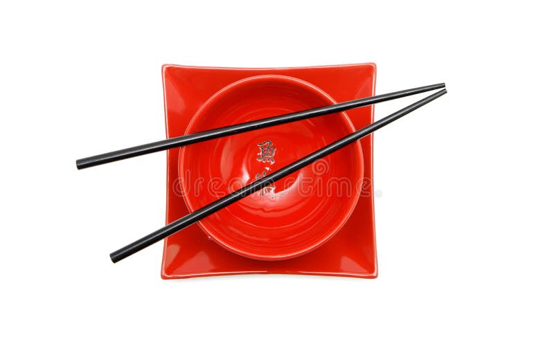 Black chopsticks on red bowl and square plate iso