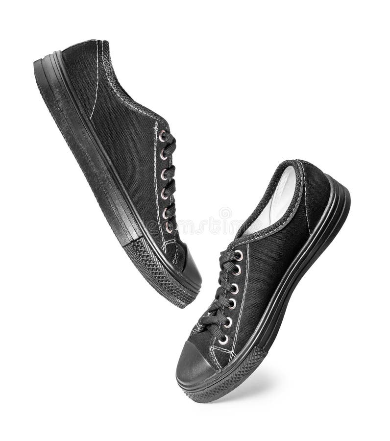 Black classic sneakers in the air isolated on white royalty free stock image Black classic sneakers in the air isolated on white royalty free stock image