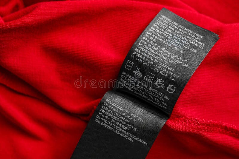 Black Clothing Labels on Red Garment, Top View Stock Photo - Image of ...