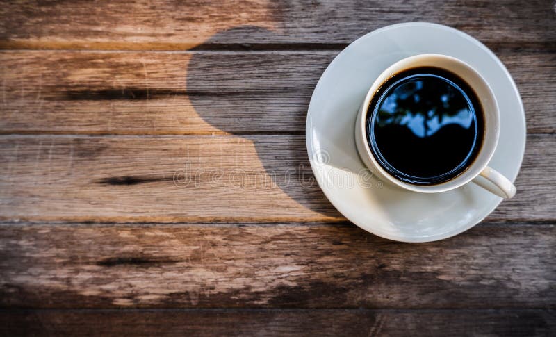 Black coffee cup with The morning sunlight on old wooden background stock photos Black coffee cup with The morning sunlight on old wooden background stock photos