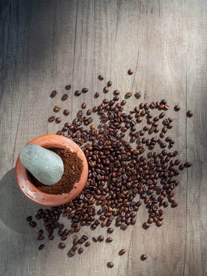 Black Coffee Ground In A Clay Mortar And In Grains On The