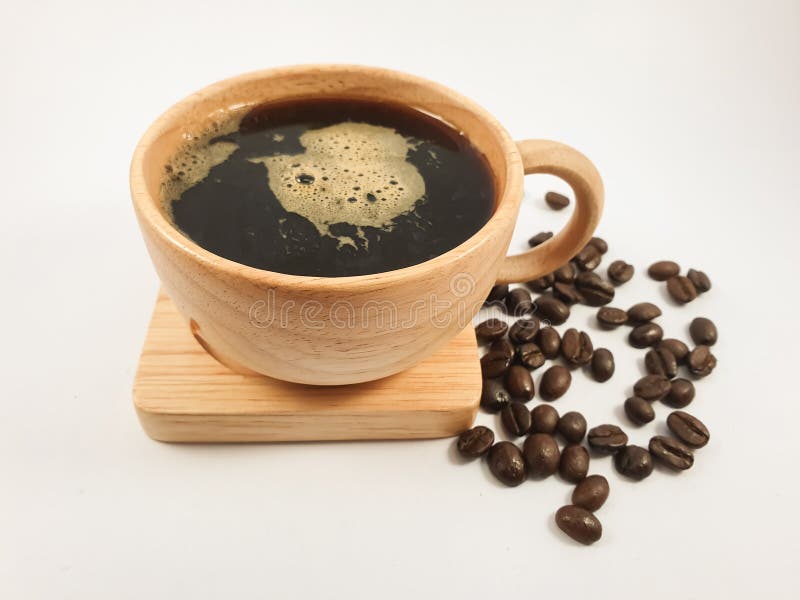 Cup Glass Of Coffee With Smoke And Coffee Beans On Old Wooden