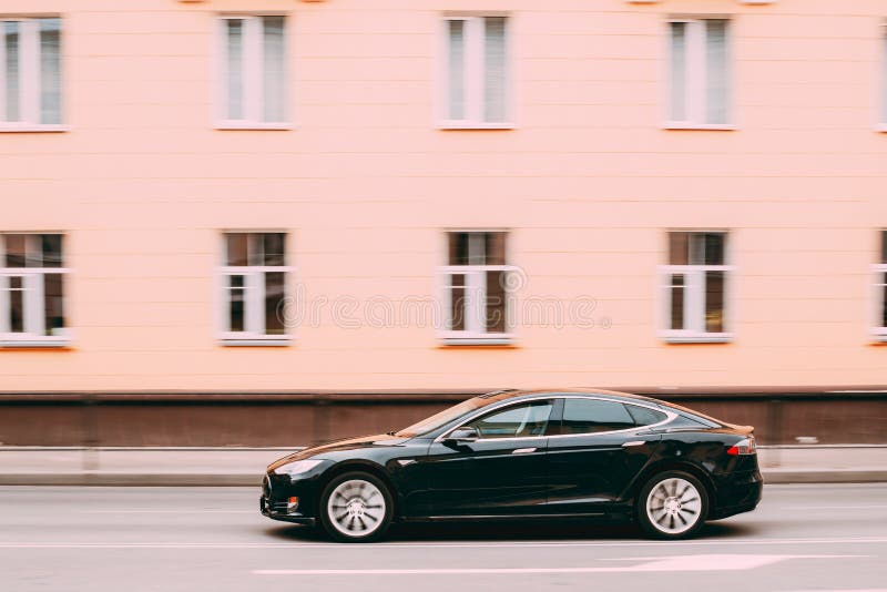 Black Color Tesla Model S Car In Motion On Street. The Tesla Model S Is A Full-sized All-electric Five-door, Luxury