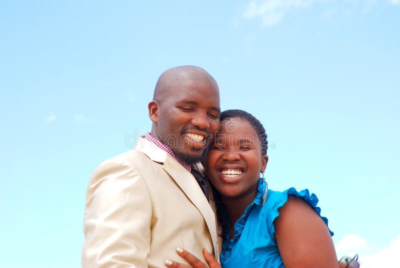 Outdoor portrait of an African American black young couple with happy smiling expression in their faces. Outdoor portrait of an African American black young couple with happy smiling expression in their faces