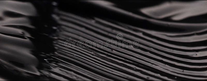 Black cream liquid creamy texture brush for drawing eyeliner, paint for artists, cosmetics for the face, decorative cosmetic stock photography