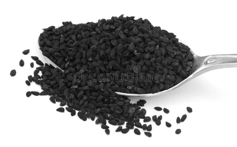 Nigella or Black cumin with a silver spoon over white background