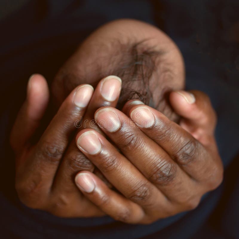 Black daddy and kid. Father holding newborn baby's head in his palms. Care concept. Black daddy and kid. Father holding newborn baby's head in his palms. Care concept.