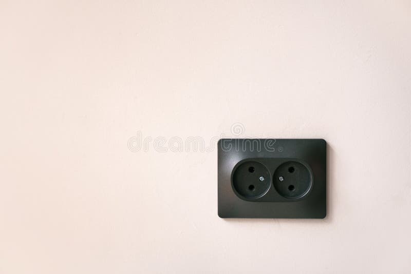 Black Double Electrical Outlet on a Light Pink Wall. Stock Image