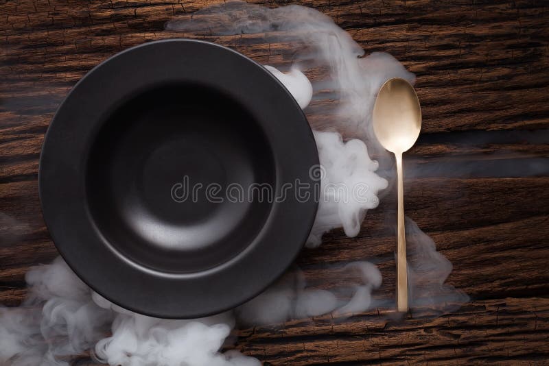 Black empty bowl spoon on wooden table background stock images