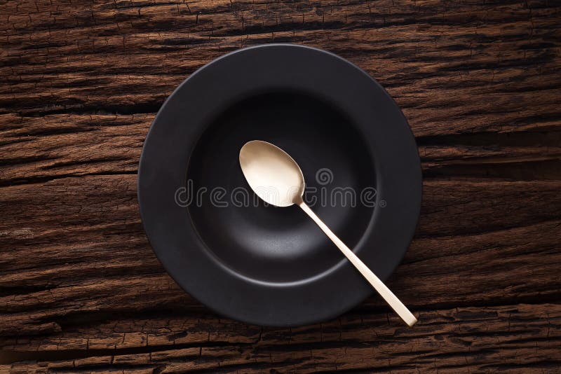 Black empty bowl spoon on wooden table background royalty free stock photography