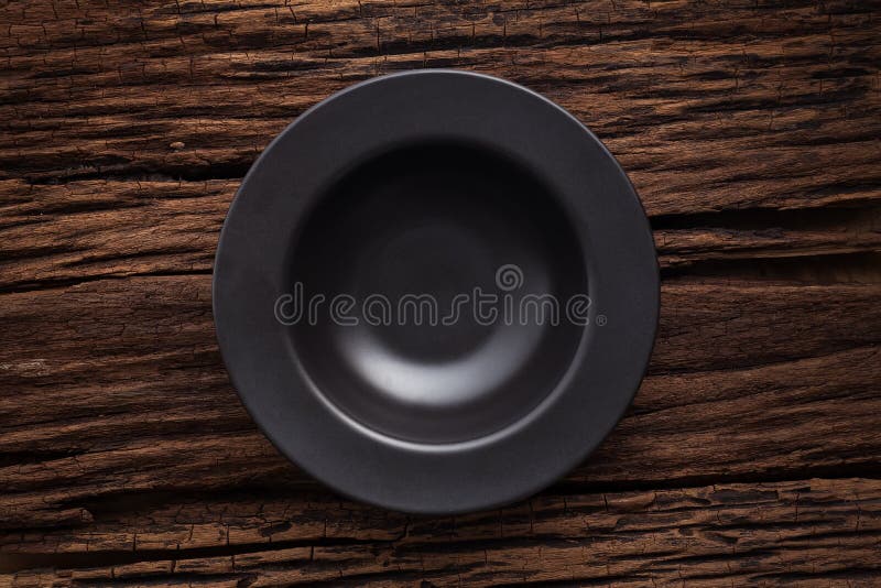Black empty bowl on wooden table background royalty free stock image