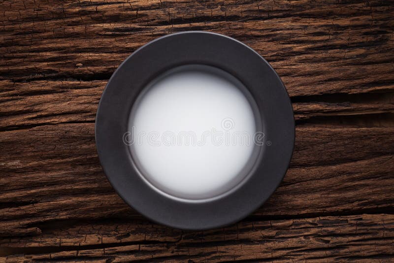 Black empty bowl on wooden table background stock photos
