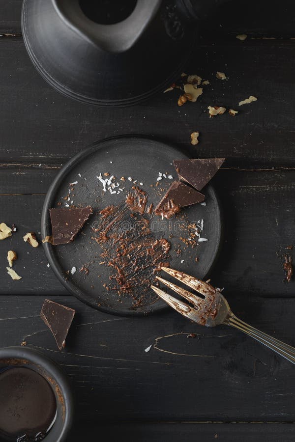 Black empty plate with cake leftovers from above stock photo Black empty plate with cake leftovers from above stock photo