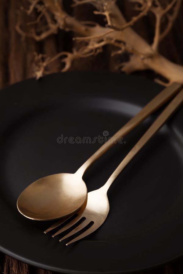 Black empty plate fork spoon on wooden table background royalty free stock images
