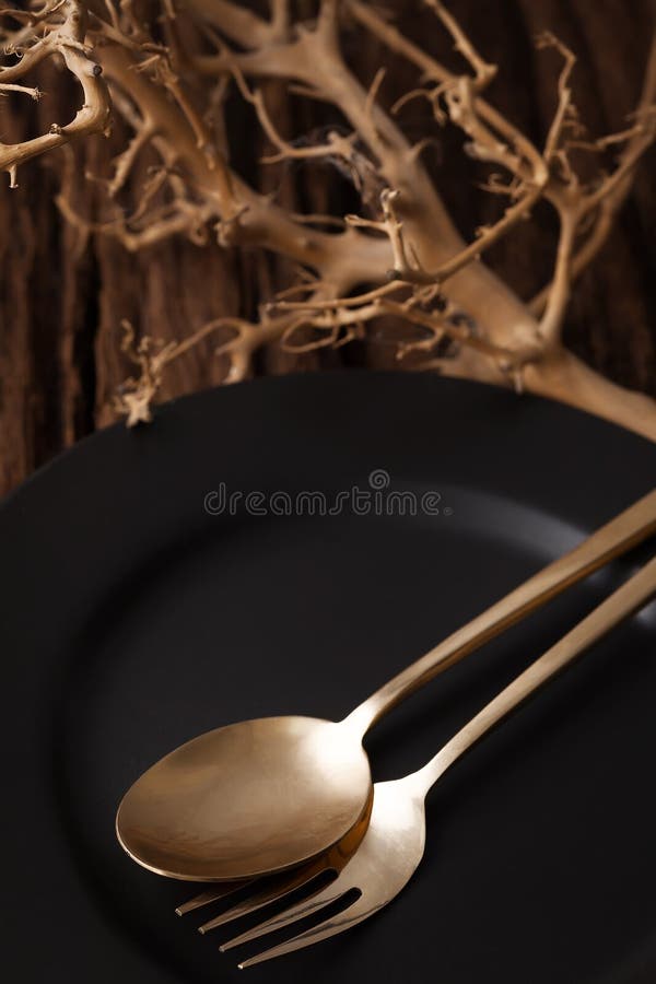 Black empty plate fork spoon on wooden table background stock image