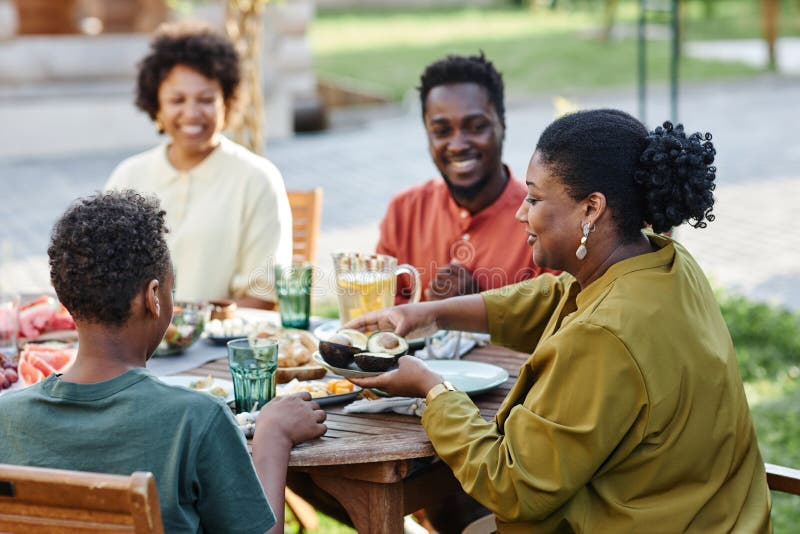 Black Family Enjoying Dinner Together Outdoors Stock Image - Image of