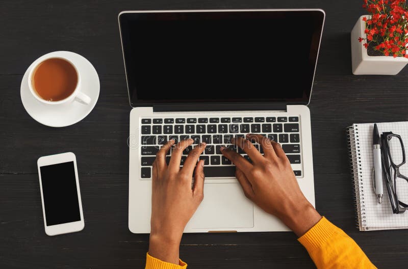 Black female hands typing on laptop. Top view of african-american woman working at office desktop with smartphone and comuter. Education, business and technology concept, copy space. Black female hands typing on laptop. Top view of african-american woman working at office desktop with smartphone and comuter. Education, business and technology concept, copy space