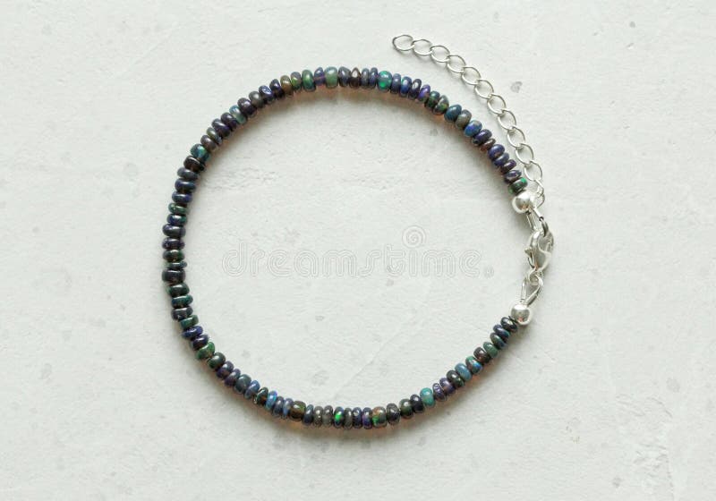 Black Fire Opal Handemade Bracelet Lies on Light Background. Bracelet ...