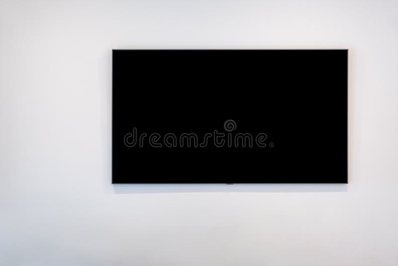 Black flat screen TV on white wall. royalty free stock images Black flat screen TV on white wall. royalty free stock images