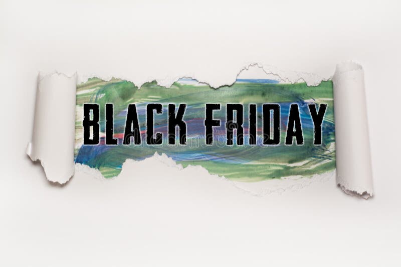 Black Friday text behind torn paper