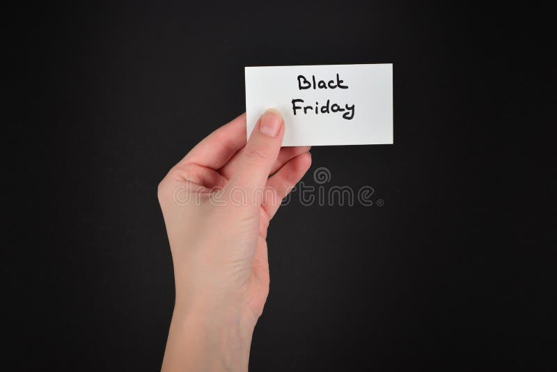 Black friday text on a card in woman on a black background stock photo Black friday text on a card in woman on a black background stock photo