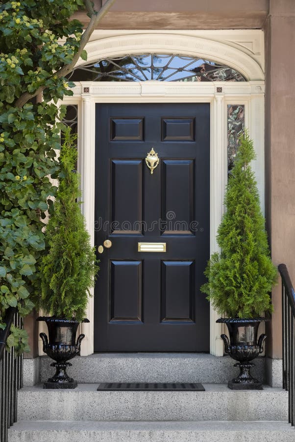 Black Front Door with White Door Frame and Greenery stock image Black Front Door with White Door Frame and Greenery stock image