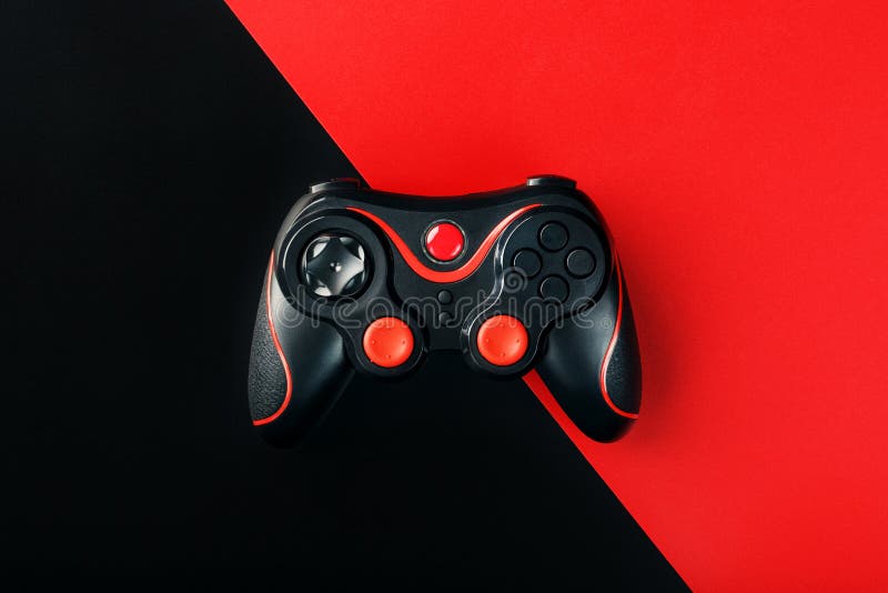 Black gamepad on a black red background, . Gaming concept