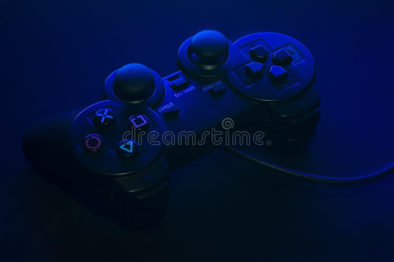 Black gamepad with blue backlight and beautiful shadows stock photography
