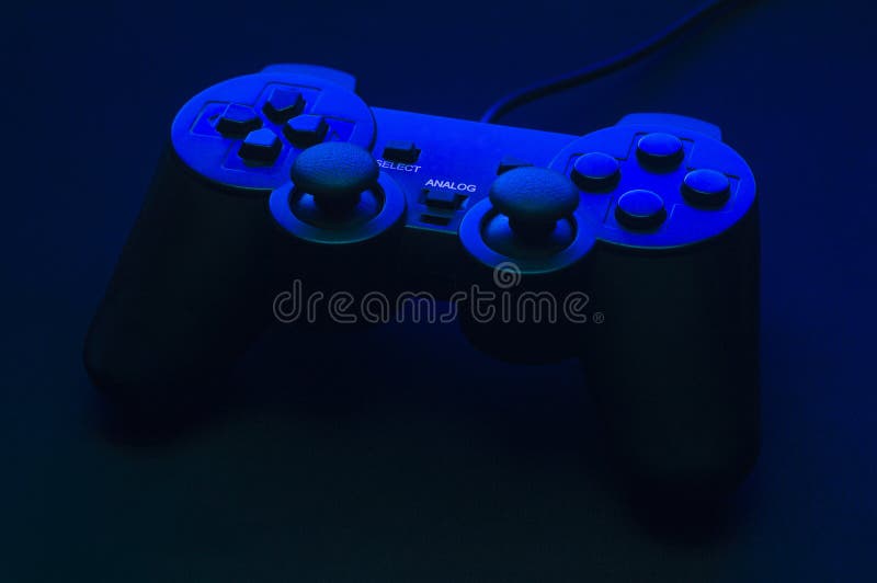 Black gamepad with blue backlight and beautiful shadows stock photos