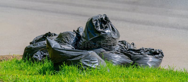 Green and black garbage bags Stock Photo by ©maurus 129875750