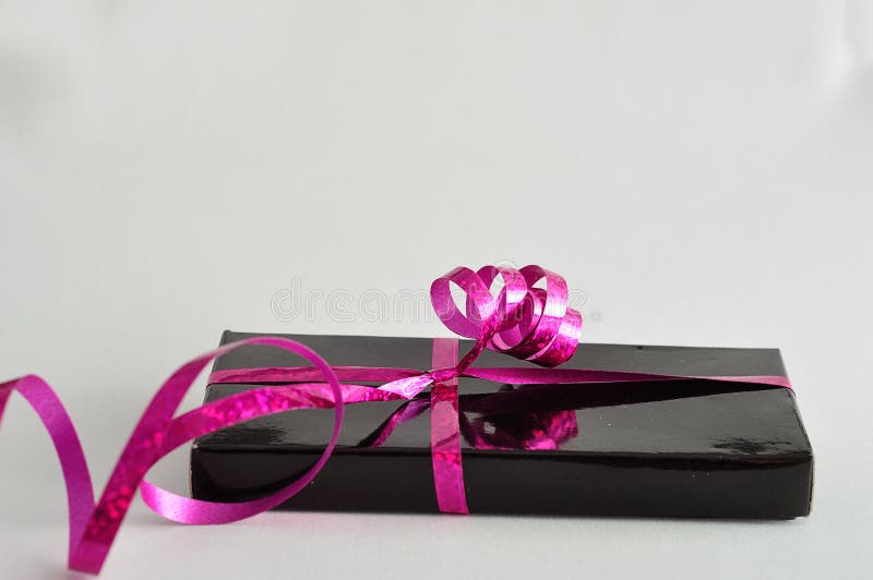 A Black Gift Box Decorated with a Pink Ribbon Stock Photo Image of