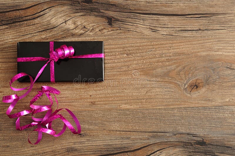 Gloria nővér Black-gift-box-decorated-pink-ribbon-wooden-background-76218097